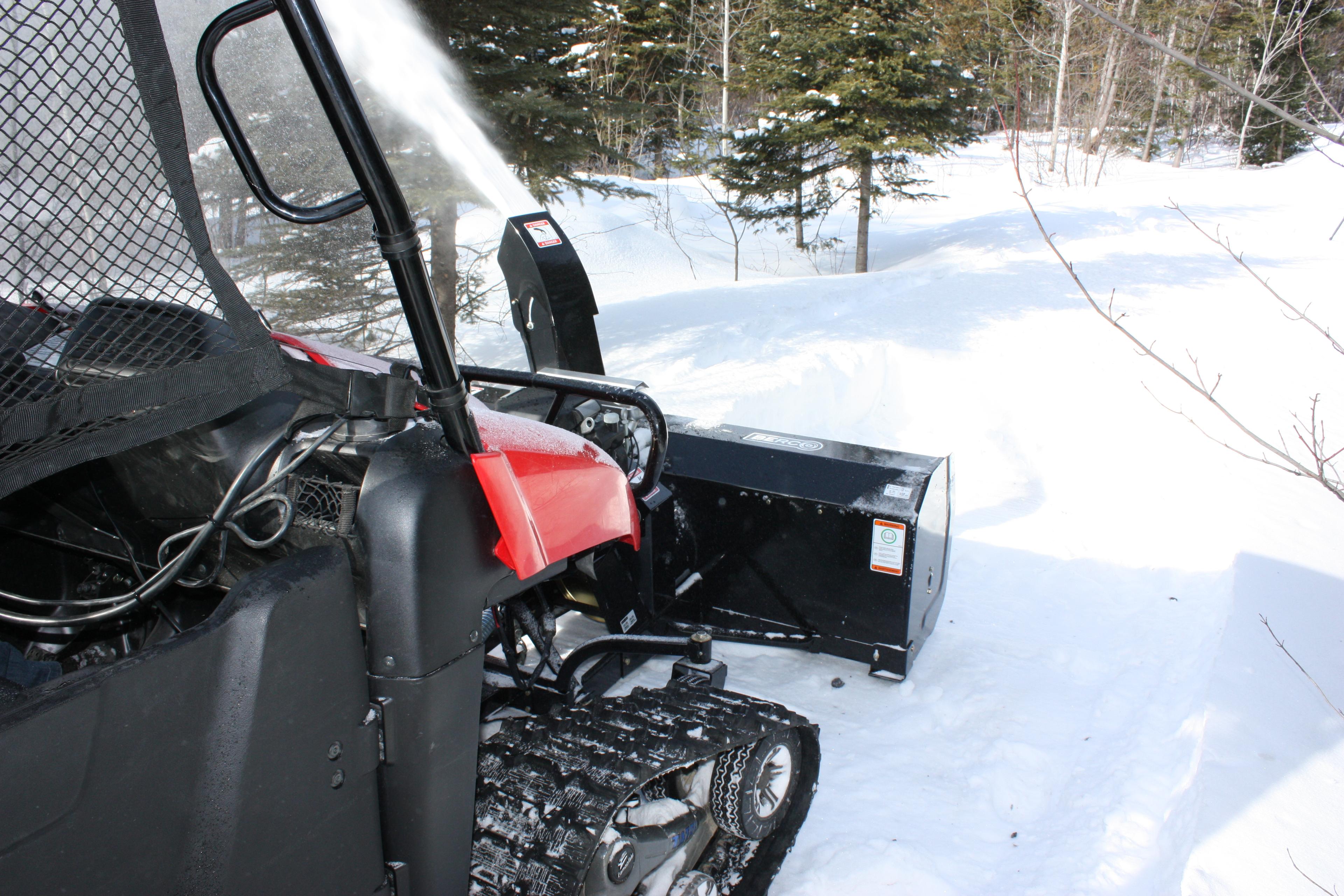 Snow blowing to the forest